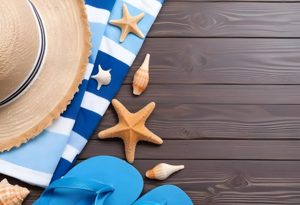 Straw Hat Blue Striped Towel Starfish Seashells And Blue Flip Flops On A Dark Brown Wooden Surface 1 9b56