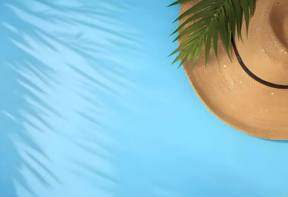 Straw Hat With A Green Palm Leaf On A Blue Wooden Table Summer Vacation Concept Tropical Vibes Vibrant Colors Top Down Perspective Bright Sunlight 19 8638