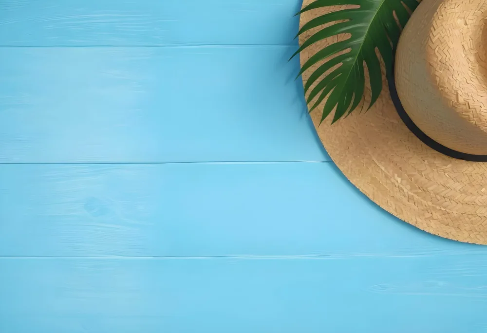 Straw Hat With A Green Palm Leaf On A Blue Wooden Table Summer Vacation Concept Tropical Vibes Vibrant Colors Top Down Perspective Bright Sunlight 21 7690