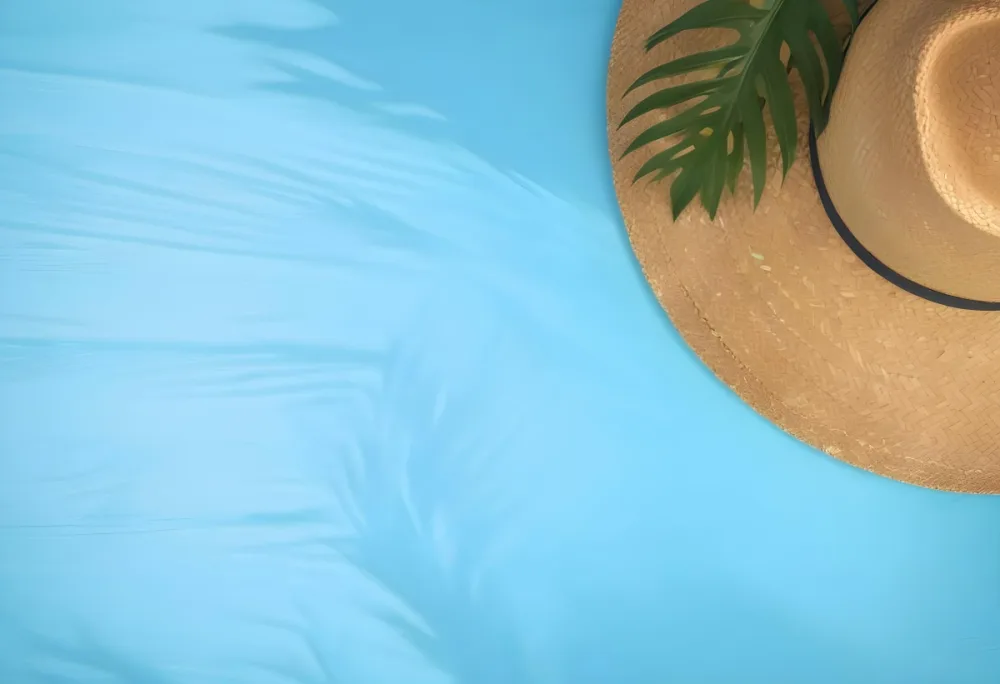 Straw Hat With A Green Palm Leaf On A Blue Wooden Table Summer Vacation Concept Tropical Vibes Vibrant Colors Top Down Perspective Bright Sunlight 4 C7db