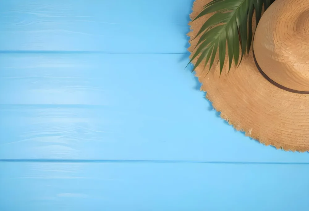 Straw Hat With A Green Palm Leaf On A Blue Wooden Table Summer Vacation Concept Tropical Vibes Vibrant Colors Top Down Perspective Bright Sunlight 6 4df6