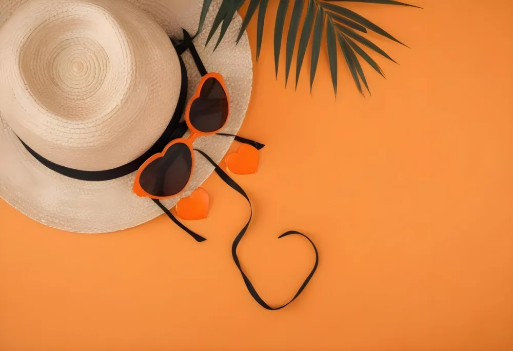 Straw Hat With Black Ribbon Heart Shaped Orange Sunglasses And A Palm Leaf On An Black Background 14 15aa