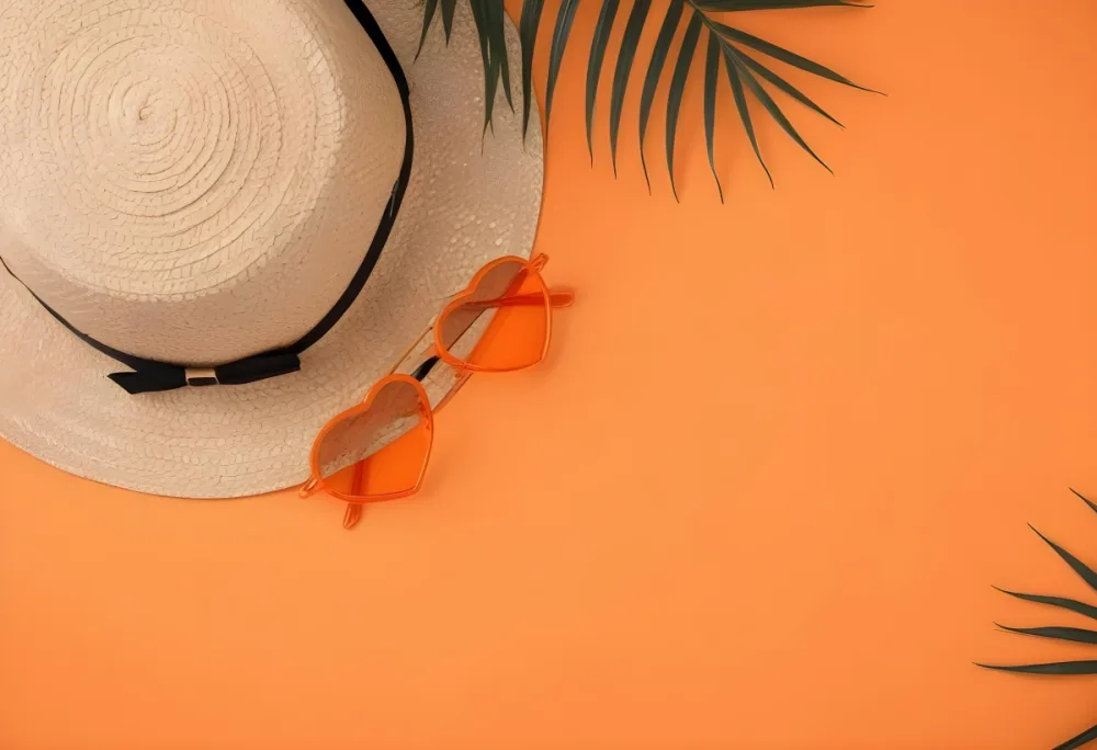 Straw Hat With Black Ribbon Heart Shaped Orange Sunglasses And A Palm Leaf On An Black Background 25 1dc0