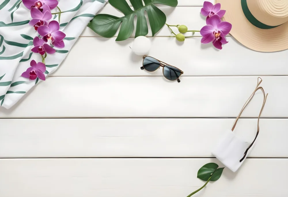 Sunglasses Sunscreen Towel Hat Orchids And Green Leaves On A White Wooden Table Top View 25 7a65