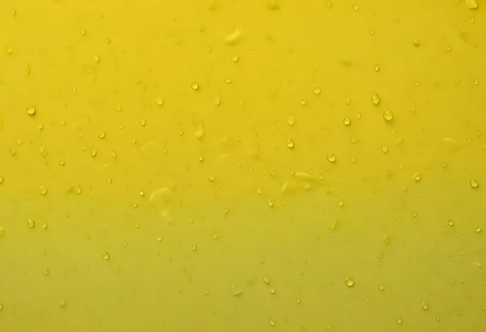 Water Droplets On A Yellow Surface The Droplets Are Small And Evenly Distributed Creating A Textured Pattern The Background Is A Gradient Of Yellow 12 1ec1