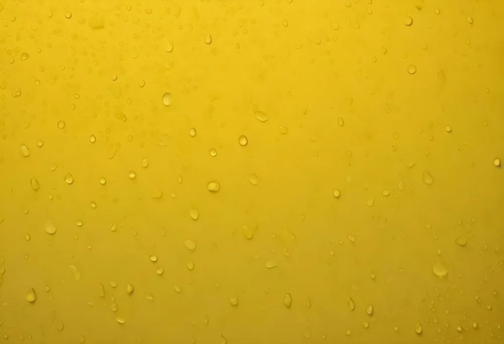 Water Droplets On A Yellow Surface The Droplets Are Small And Evenly Distributed Creating A Textured Pattern The Background Is A Gradient Of Yellow 20 Bb16