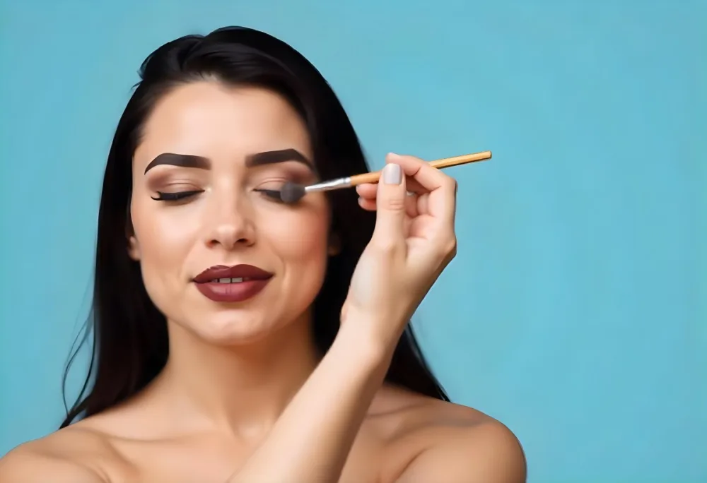 A 22 Year Old Hispanic Woman With Blue Hair Applying Makeup With A Brush Black Lipstick Closed Eyes In A Black Background 9 7631