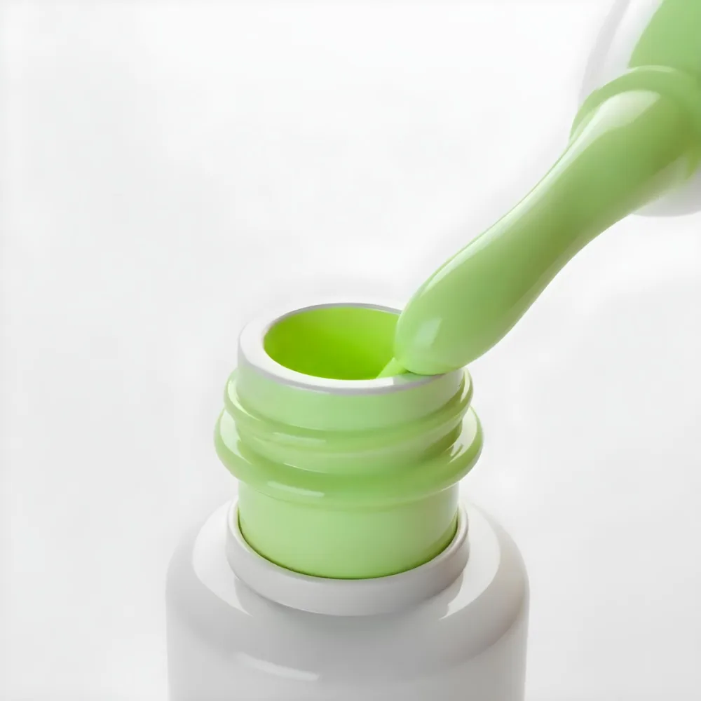 A Bottle Of Light Green Nail Polish With The Brush Inside The Bottle Is White Plain Background 18 B09a