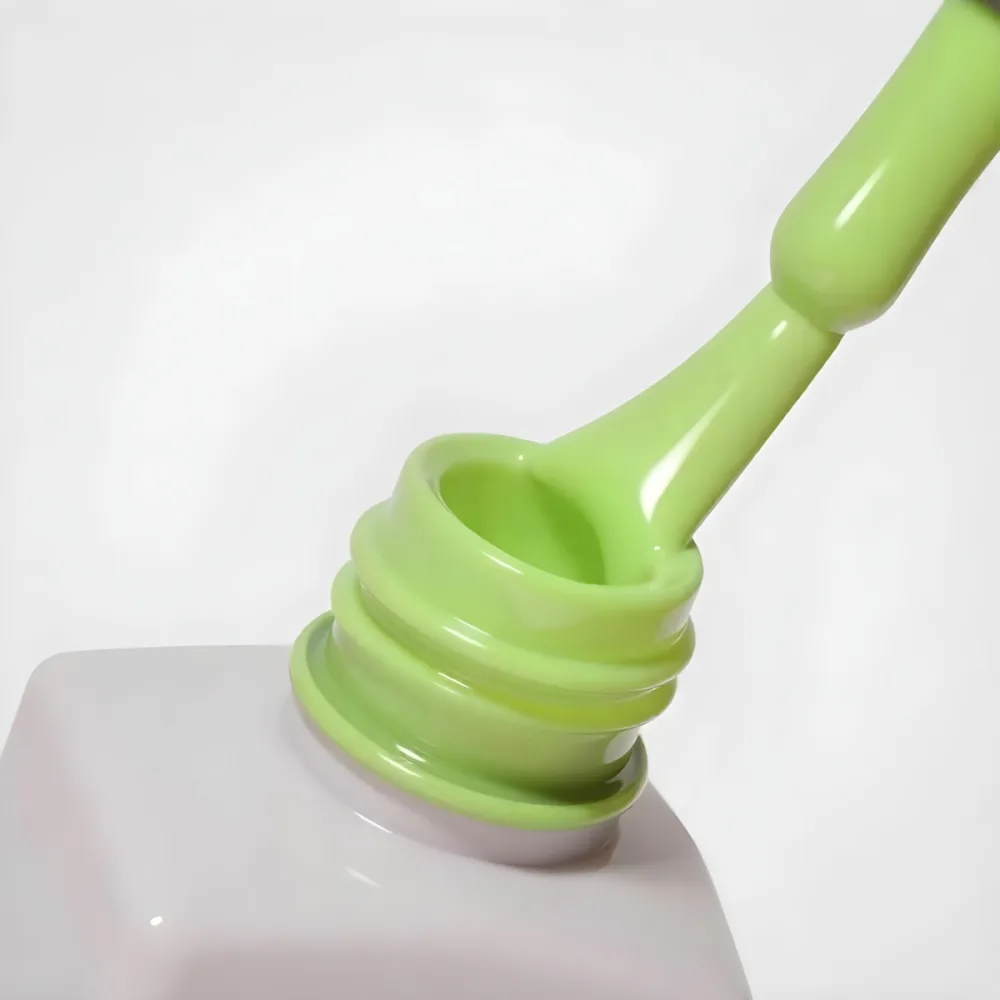 A Bottle Of Light Green Nail Polish With The Brush Inside The Bottle Is White Plain Background 7 46e1