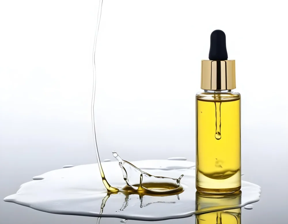 A Bottle Of Yellow Oil With A Dropper A Splash Of Oil On A White Surface And A White Background 4 D702
