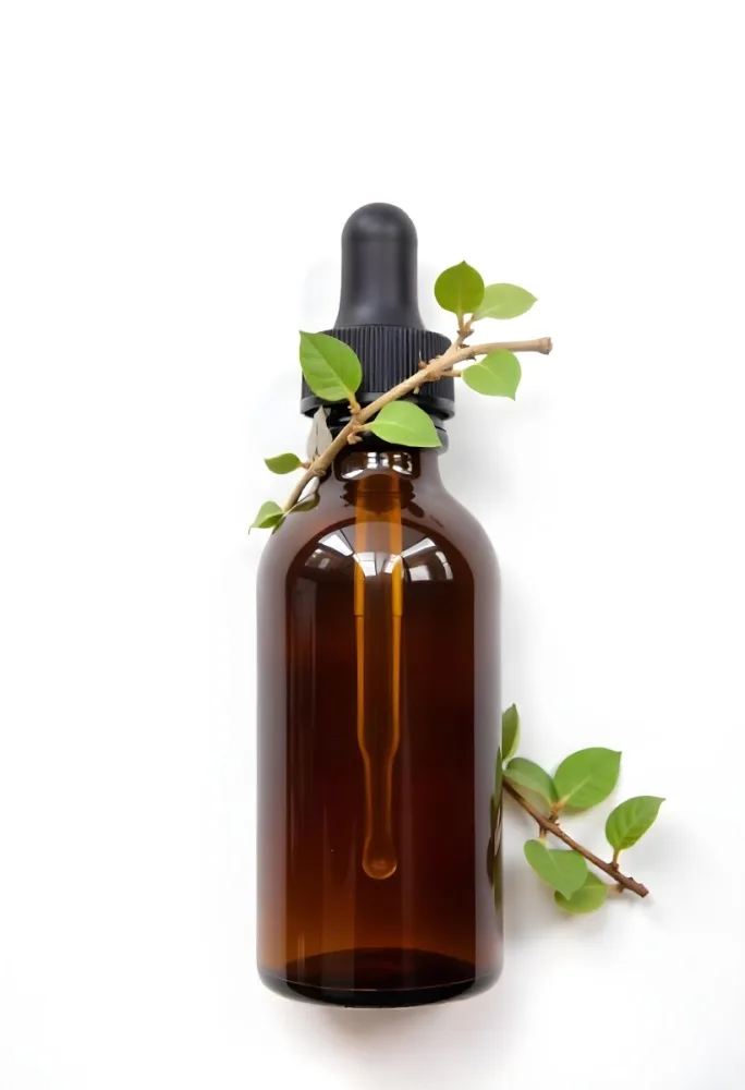 A Brown Glass Bottle With A Dropper And Green Leaves Around It Suggesting A Natural Product For Herbal Use 7