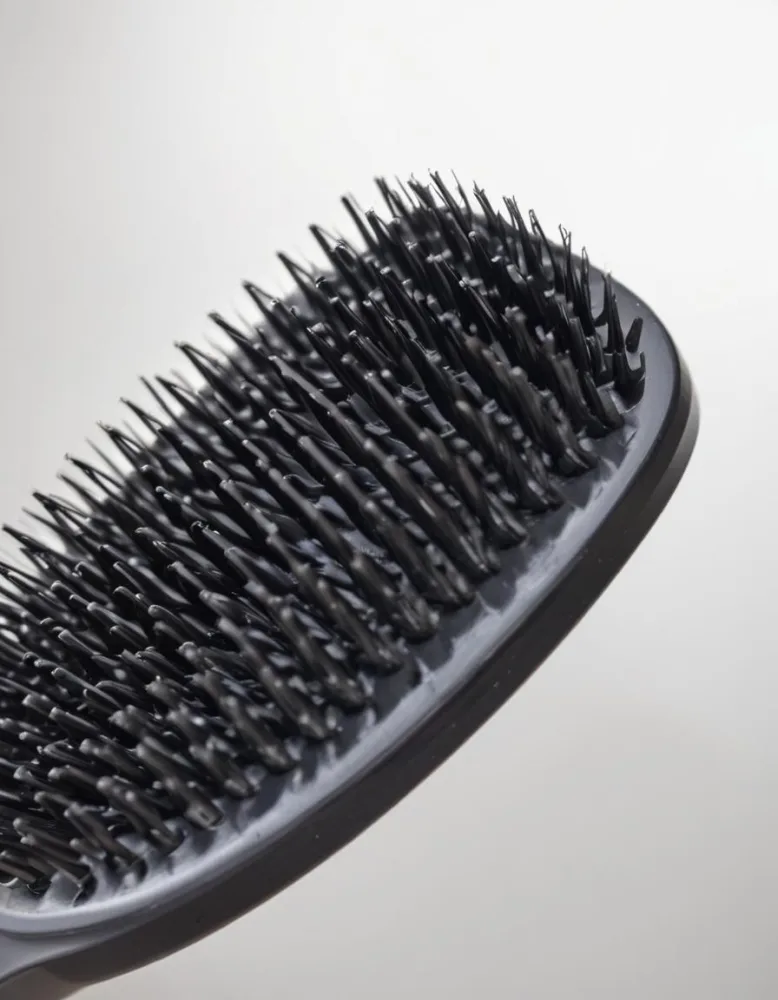 A Close Up View Of A Black Hair Brush With Dense Rigid Bristles 1 D618