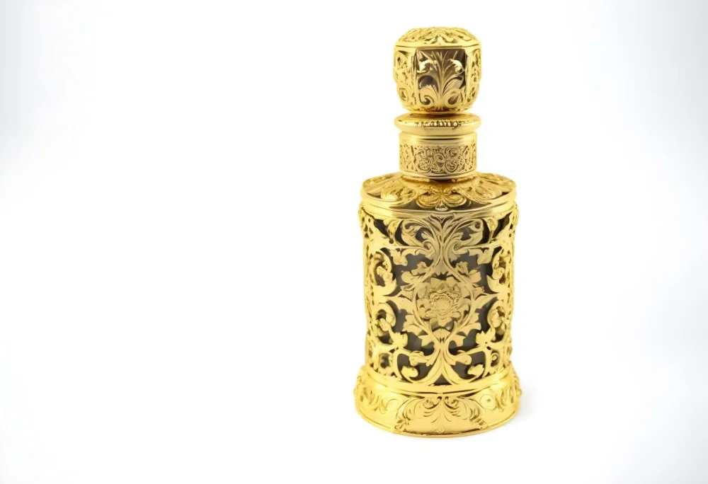 A Golden Ornate Perfume Bottle With An Intricate Floral Pattern 34 F064