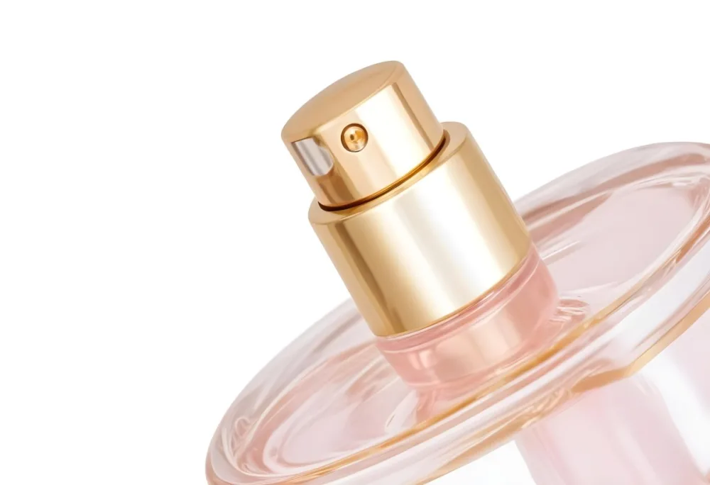 A Perfume Bottle With A Golden Cap And A Golden Spray Nozzle Clear Glass And A Light Pink Liquid Inside Isolated On A White Background 1 3967