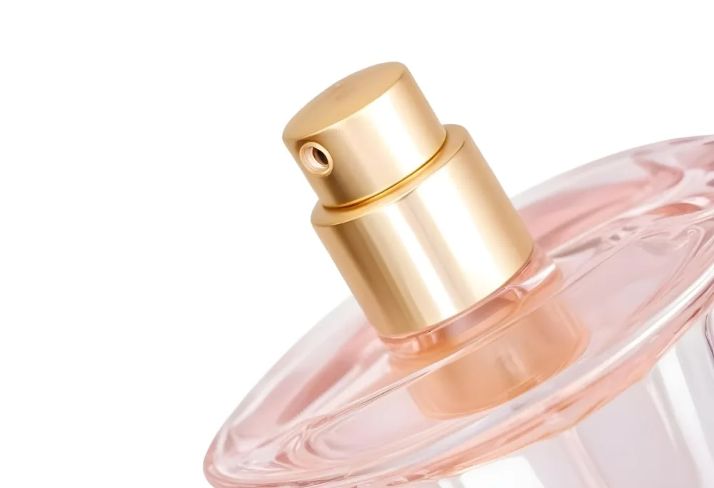 A Perfume Bottle With A Golden Cap And A Golden Spray Nozzle Clear Glass And A Light Pink Liquid Inside Isolated On A White Background 27 7828