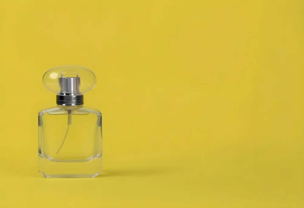A Perfume Bottle With A Transparent Cap And A Transparent Atomizer On A Yellow Background 19 Bc06