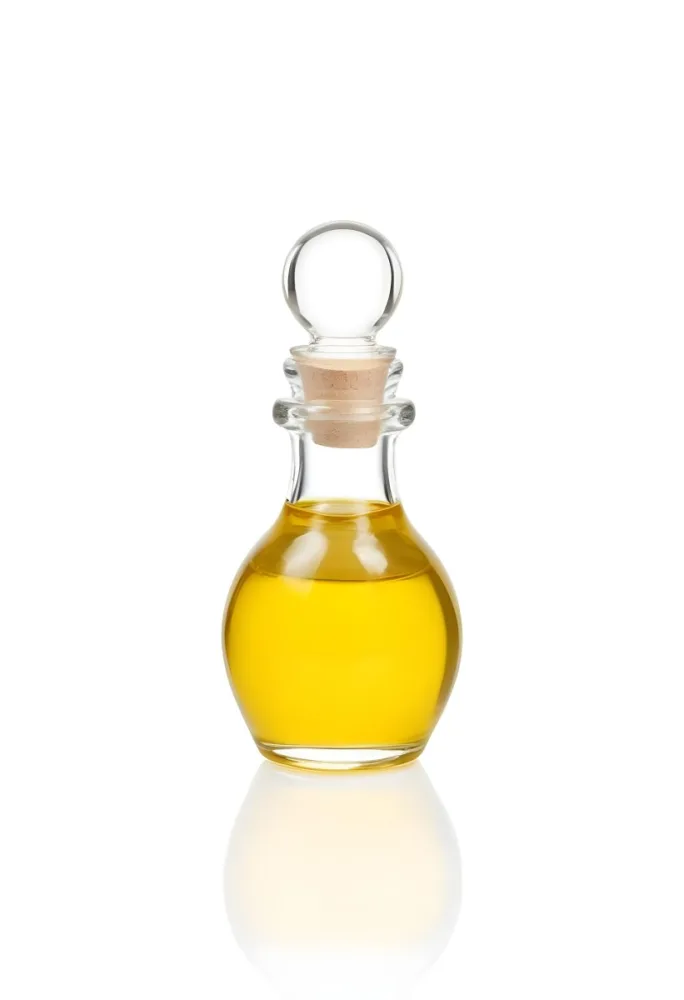 A Small Glass Bottle With A Round Stopper Filled With Yellow Liquid On A White Background 17 Dbae