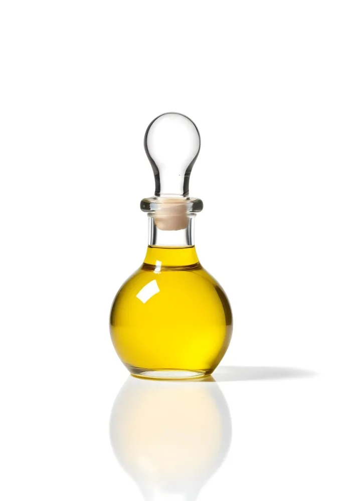 A Small Glass Bottle With A Round Stopper Filled With Yellow Liquid On A White Background 7 E954