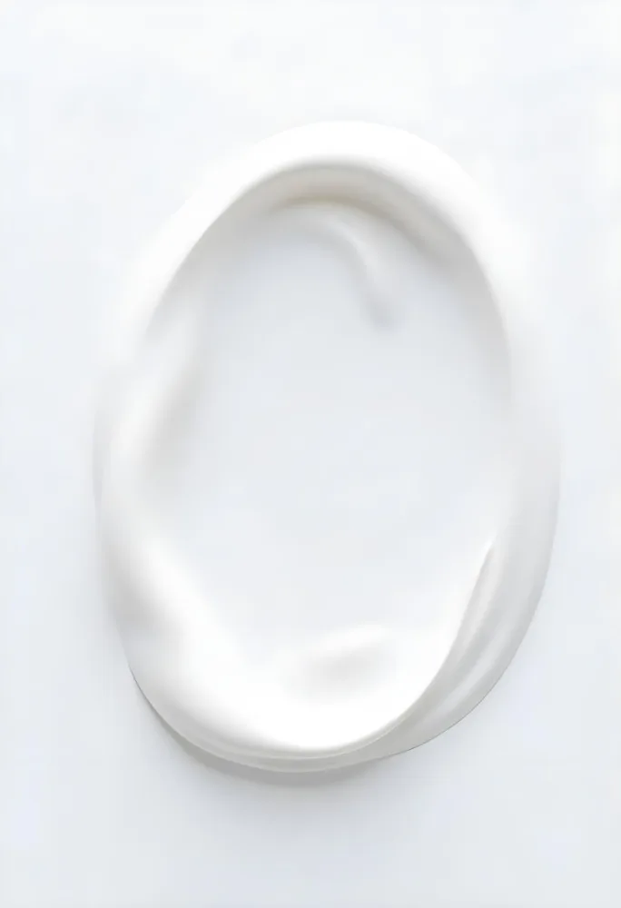 A Smear Of White Cream With A Smooth Texture Swirled On A Clean White Surface Creating A Simple Minimalist Composition 35 9727