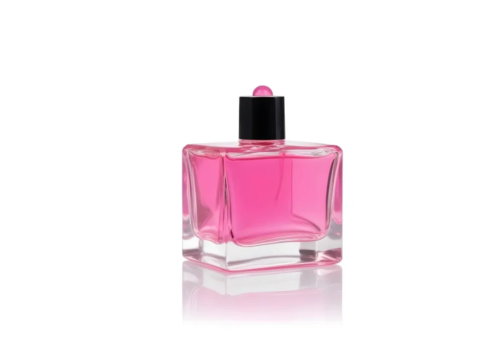 A Square Glass Perfume Bottle With A Pink Cap Filled With Bright Pink Liquid On A Black Background 16 4c8a