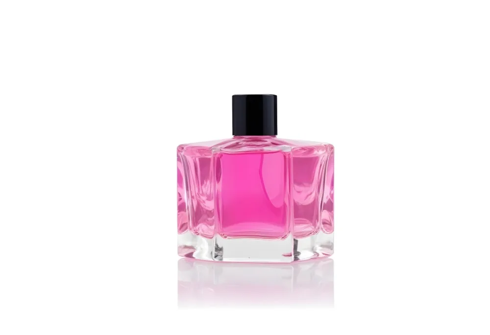 A Square Glass Perfume Bottle With A Pink Cap Filled With Bright Pink Liquid On A Black Background 17 9684