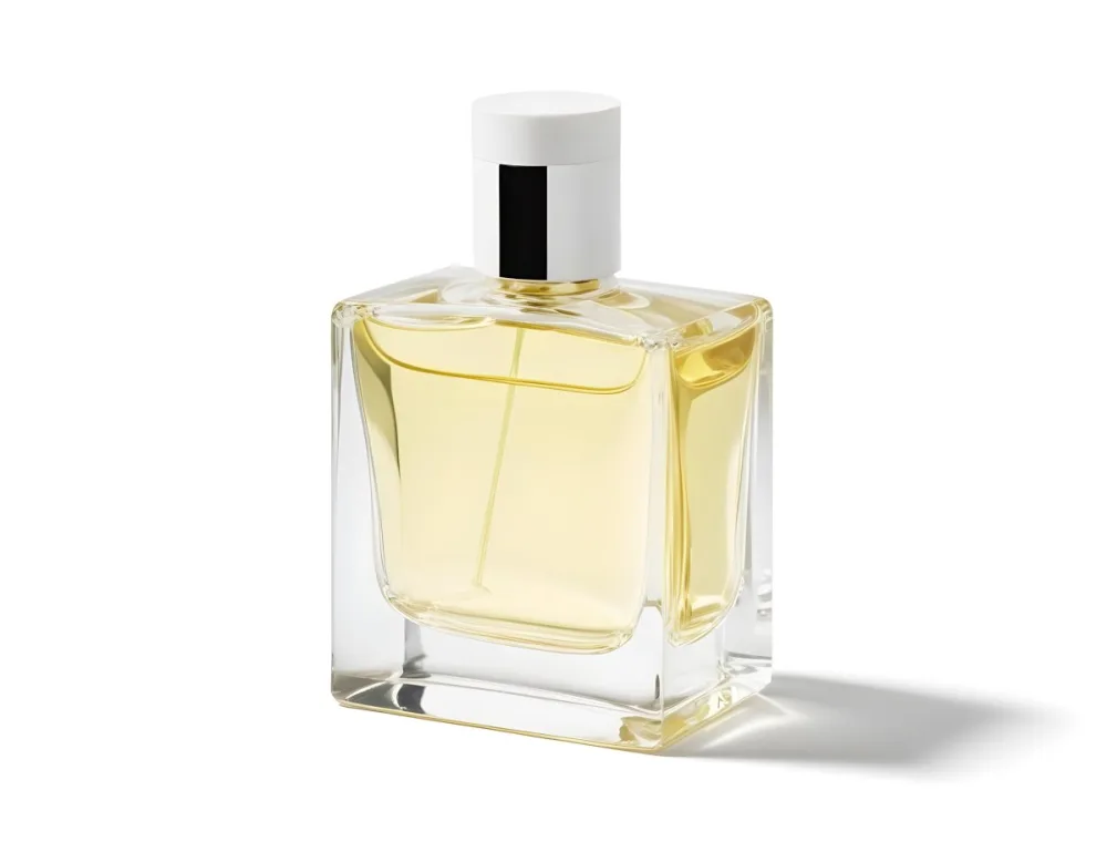 A Square Perfume Bottle With A White Cap Filled With A Light Yellow Liquid On A White Background 21 Fd46