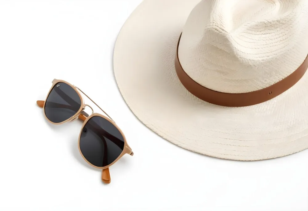 A Straw Hat With A White Leather Band And A Pair Of Sunglasses On A White Surface 4 18e2