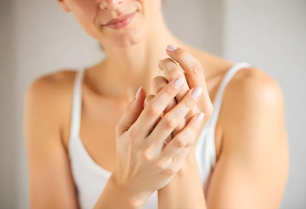 A White Woman 25 Years Old With Fair Skin And Brown Hair Applying Cream On Her Hands In A Bright Room 12 C508