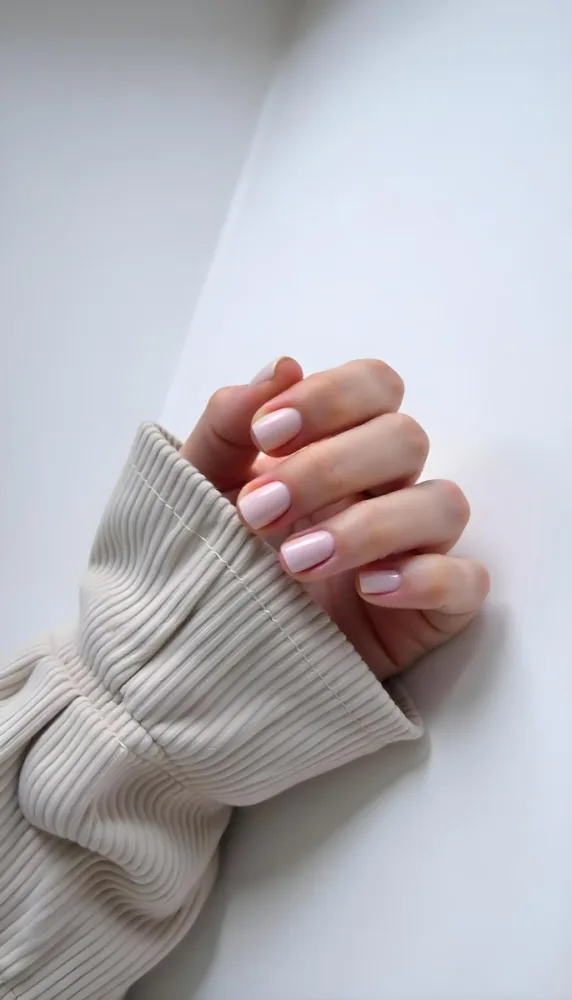 A Woman S Hand With Pale Skin And Short White Nails Wearing A Beige Corduroy Shirt On A White Background 22 1a9c