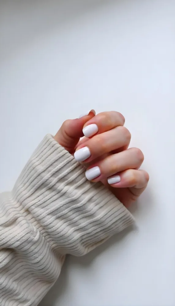 A Woman S Hand With Pale Skin And Short White Nails Wearing A Beige Corduroy Shirt On A White Background 26 51d1