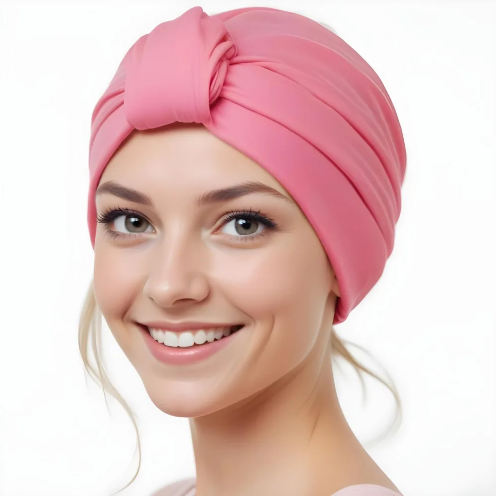 A Young Caucasian Woman With Long Blonde Hair Wearing A Pink Turban Style Headwrap Smiling At The Camera 4 2996