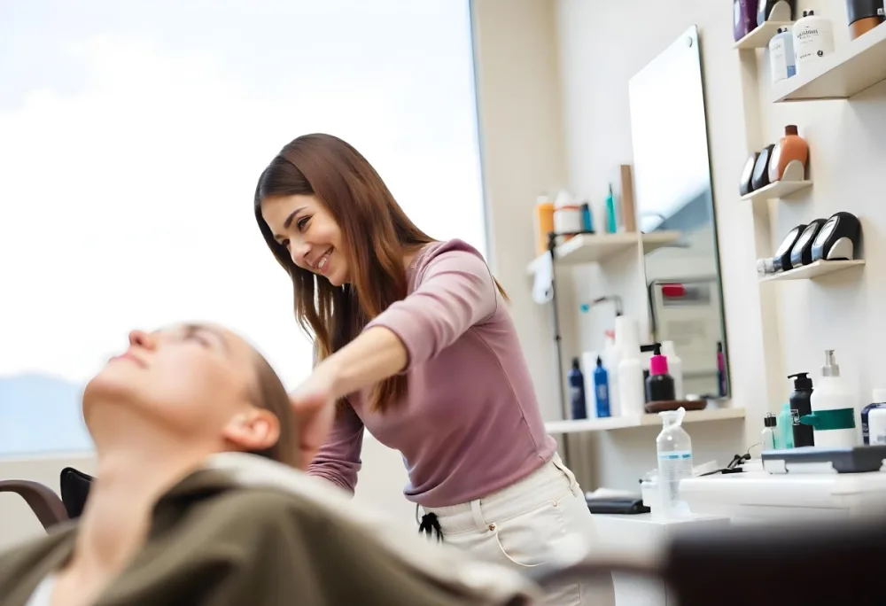 A Young Caucasian Woman With Long Brown Hair In A Pink Shirt Styling The Hair Of A Young Girl With Short Brown Hair In A Salon Setting 3 3836