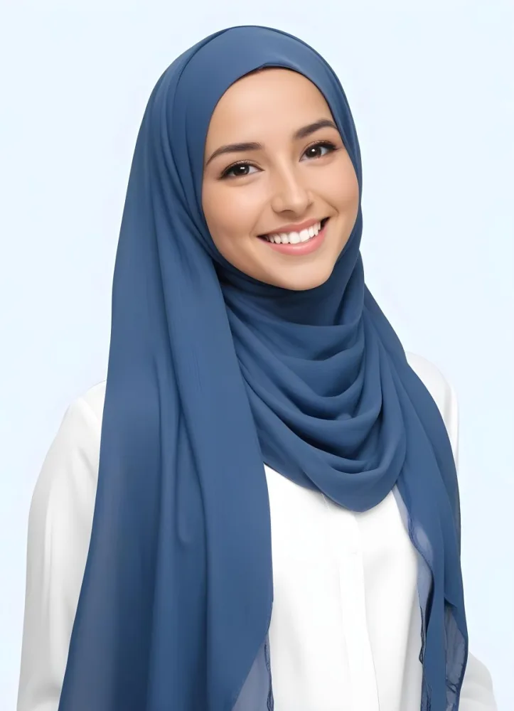 A Young Middle Eastern Woman With Dark Hair Wearing A Blue Hijab And Smiling At The Camera 14 883e