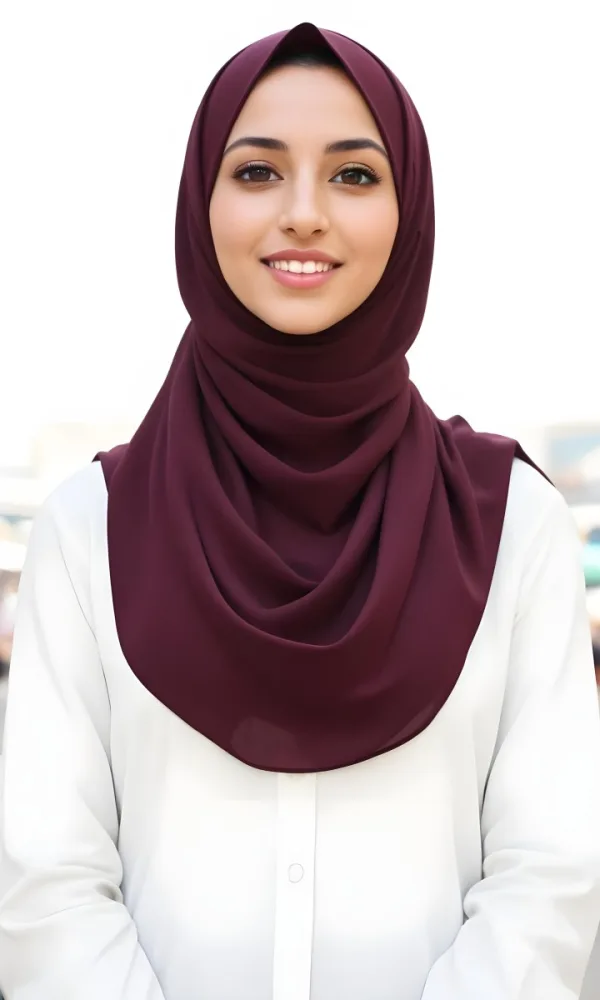 A Young Middle Eastern Woman With Dark Hair Wearing A Burgundy Hijab Smiling At The Camera 2 Eb62