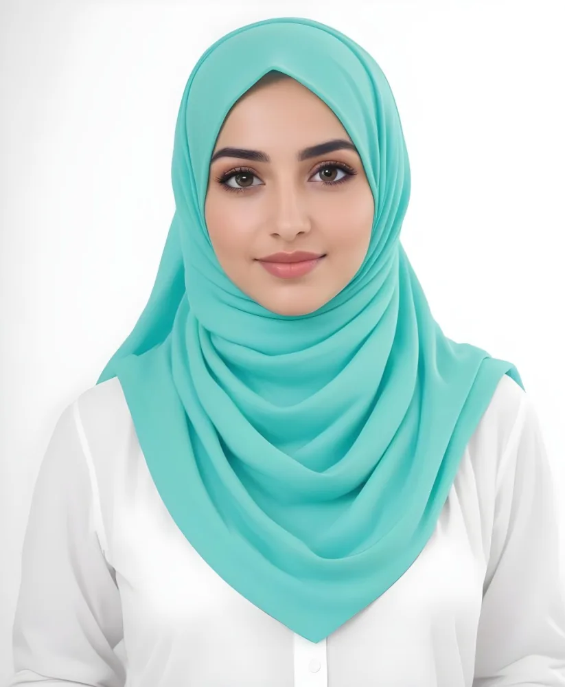 A Young Middle Eastern Woman With Dark Hair Wearing A Teal Hijab Looking Directly At The Camera With A Slight Smile In A Park During Daytime 12 3746