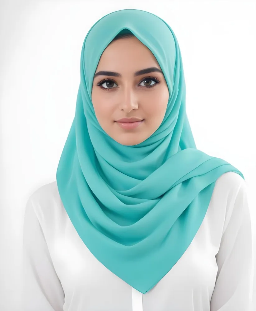 A Young Middle Eastern Woman With Dark Hair Wearing A Teal Hijab Looking Directly At The Camera With A Slight Smile In A Park During Daytime 13 2a83