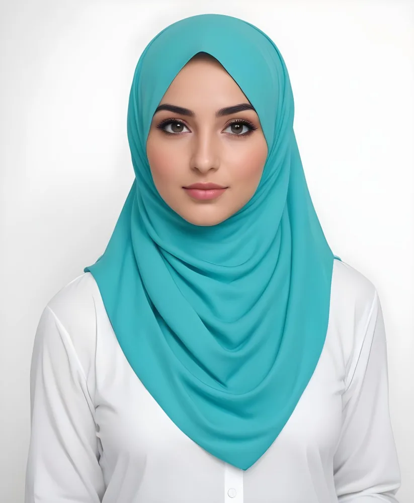 A Young Middle Eastern Woman With Dark Hair Wearing A Teal Hijab Looking Directly At The Camera With A Slight Smile In A Park During Daytime 14 0624