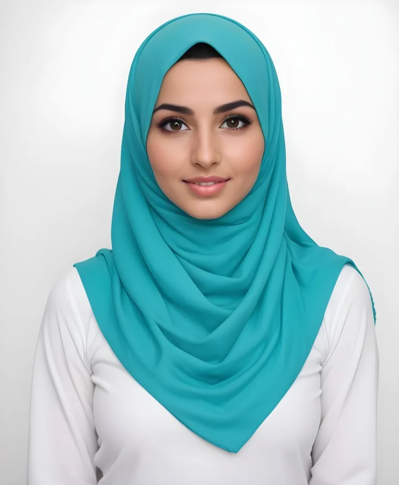 A Young Middle Eastern Woman With Dark Hair Wearing A Teal Hijab Looking Directly At The Camera With A Slight Smile In A Park During Daytime 15 Ff52