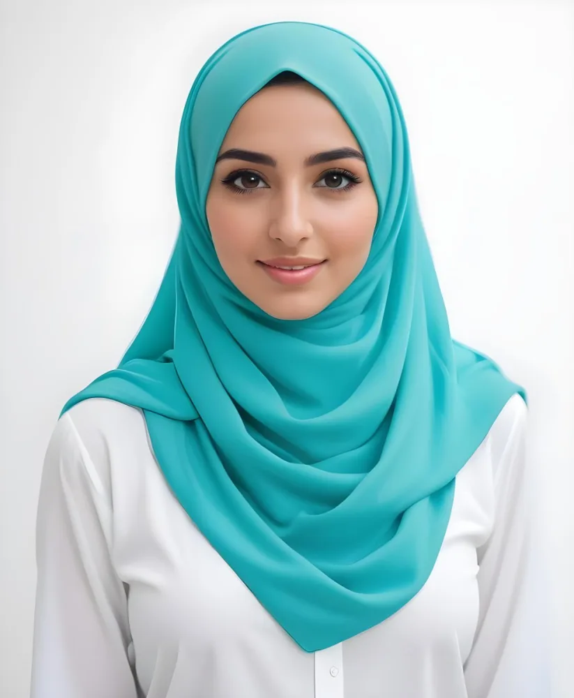 A Young Middle Eastern Woman With Dark Hair Wearing A Teal Hijab Looking Directly At The Camera With A Slight Smile In A Park During Daytime 4 F309