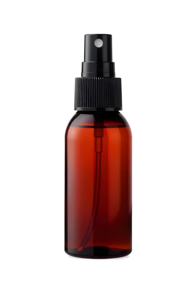 An Amber Glass Spray Bottle With A White Spray Nozzle The Bottle Is Empty The Background Is Black 11 Ec17