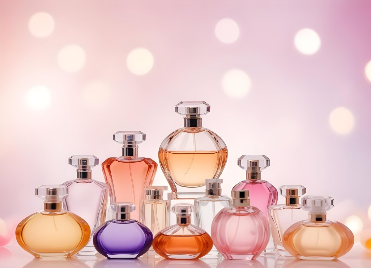 Many Perfume Bottles Of Different Shapes And Colors In A Studio With A Pink And White Bokeh Background 11 275d