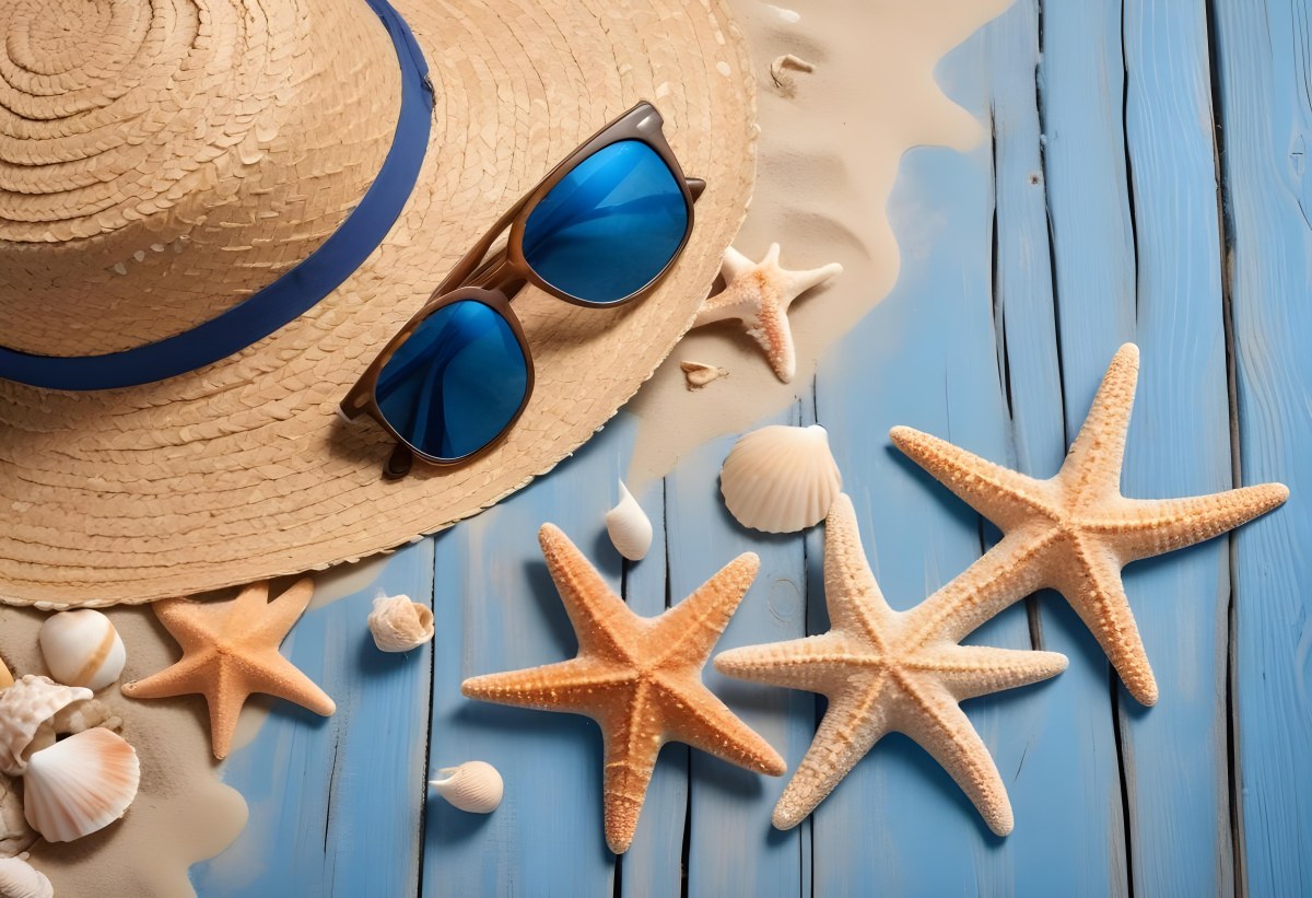 Straw Hat And Sunglasses Next To Seashells And A Starfish On A Sandy Beach With A Blue Wooden Surface In The Background 4 8937