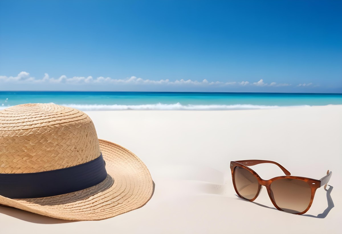 Straw Hat And Sunglasses On A White Sand Beach With A Clear Blue Sky And Ocean In The Background 33 352d