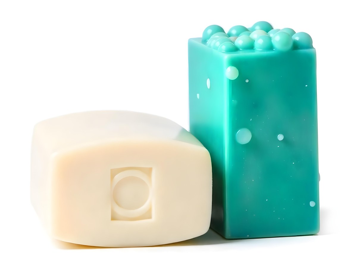 Two Bars Of Soap One White And One Green With Bubbles On Top In A White Background 10 51f0