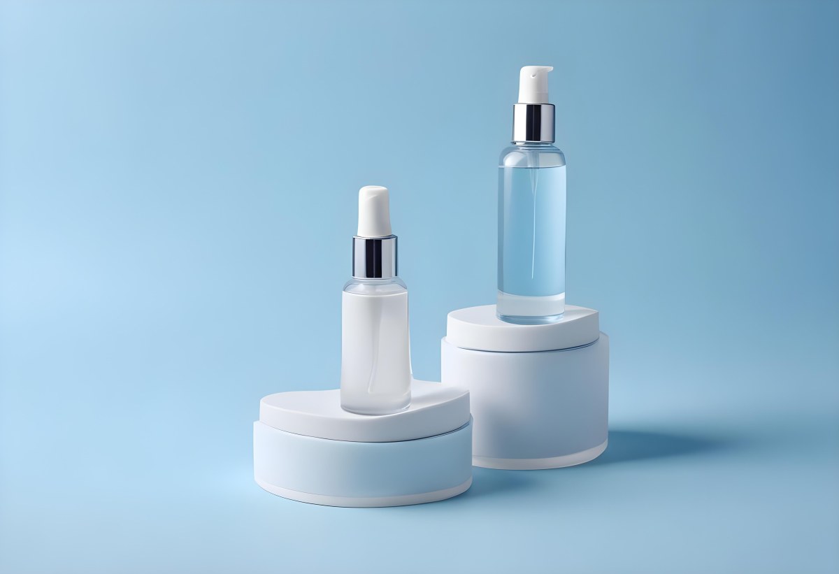 Two Cosmetic Bottles With Droppers One With A Blue Liquid And The Other Transparent On Top Of White Platforms With A Light Blue Background 50 8510