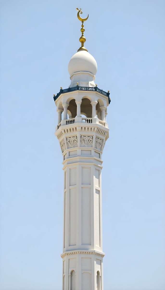 A Tall White Minaret With Blue Roof And Intricate Details Against A Clear Blue Sky Showcasing Islamic Architecture And Design 24 7833
