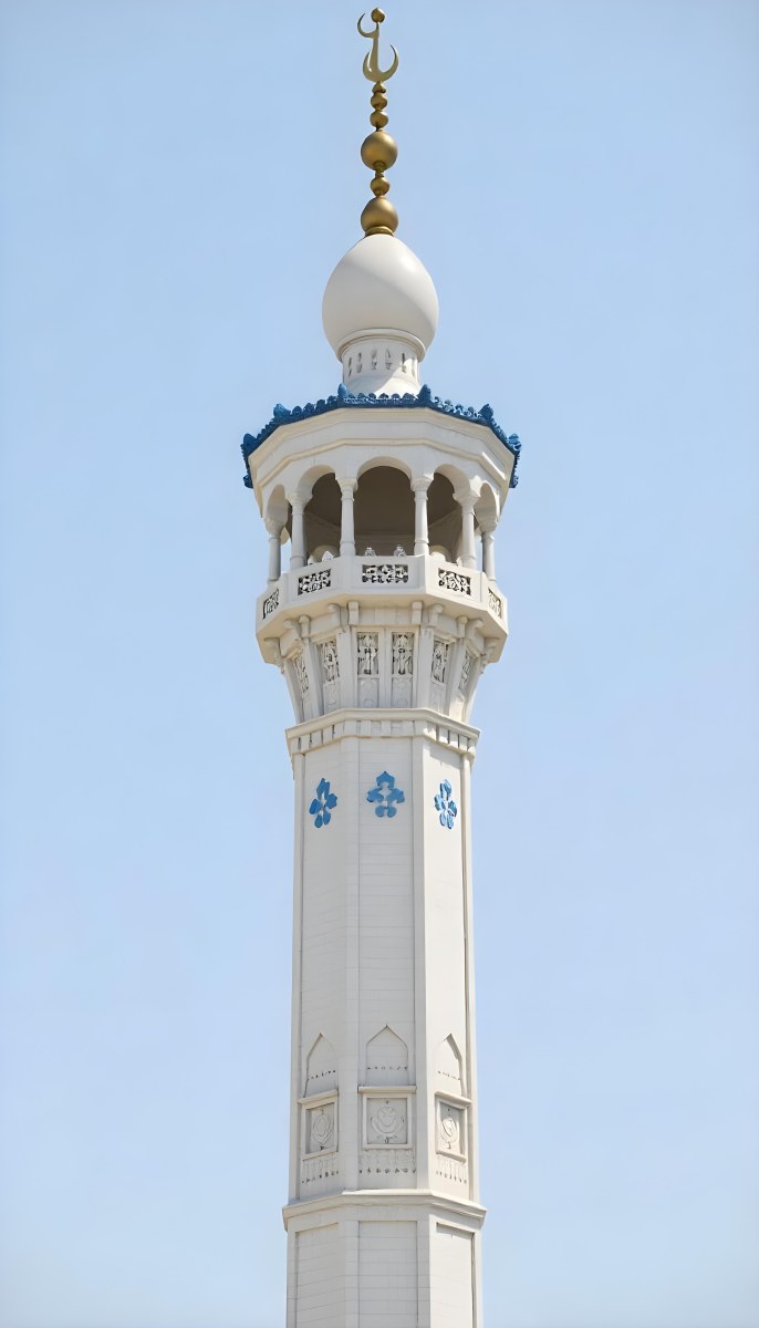 A Tall White Minaret With Blue Roof And Intricate Details Against A Clear Blue Sky Showcasing Islamic Architecture And Design 40 2dd7