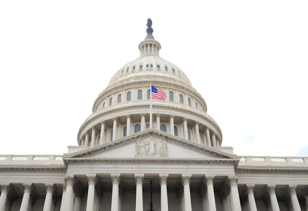 The United States Capitol Building With The American Flag Waving In The Wind The Sky Is White 2 9124