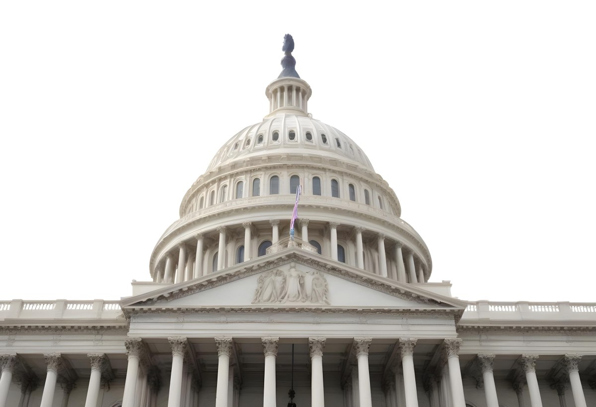 The United States Capitol Building With The American Flag Waving In The Wind The Sky Is White 20 525e