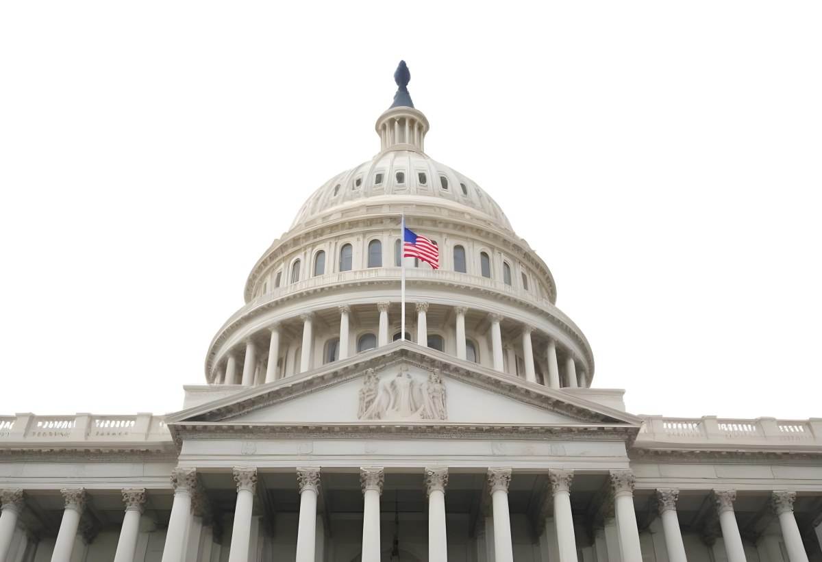 The United States Capitol Building With The American Flag Waving In The Wind The Sky Is White 22 903e